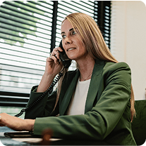 Woman in green blazer on phone.